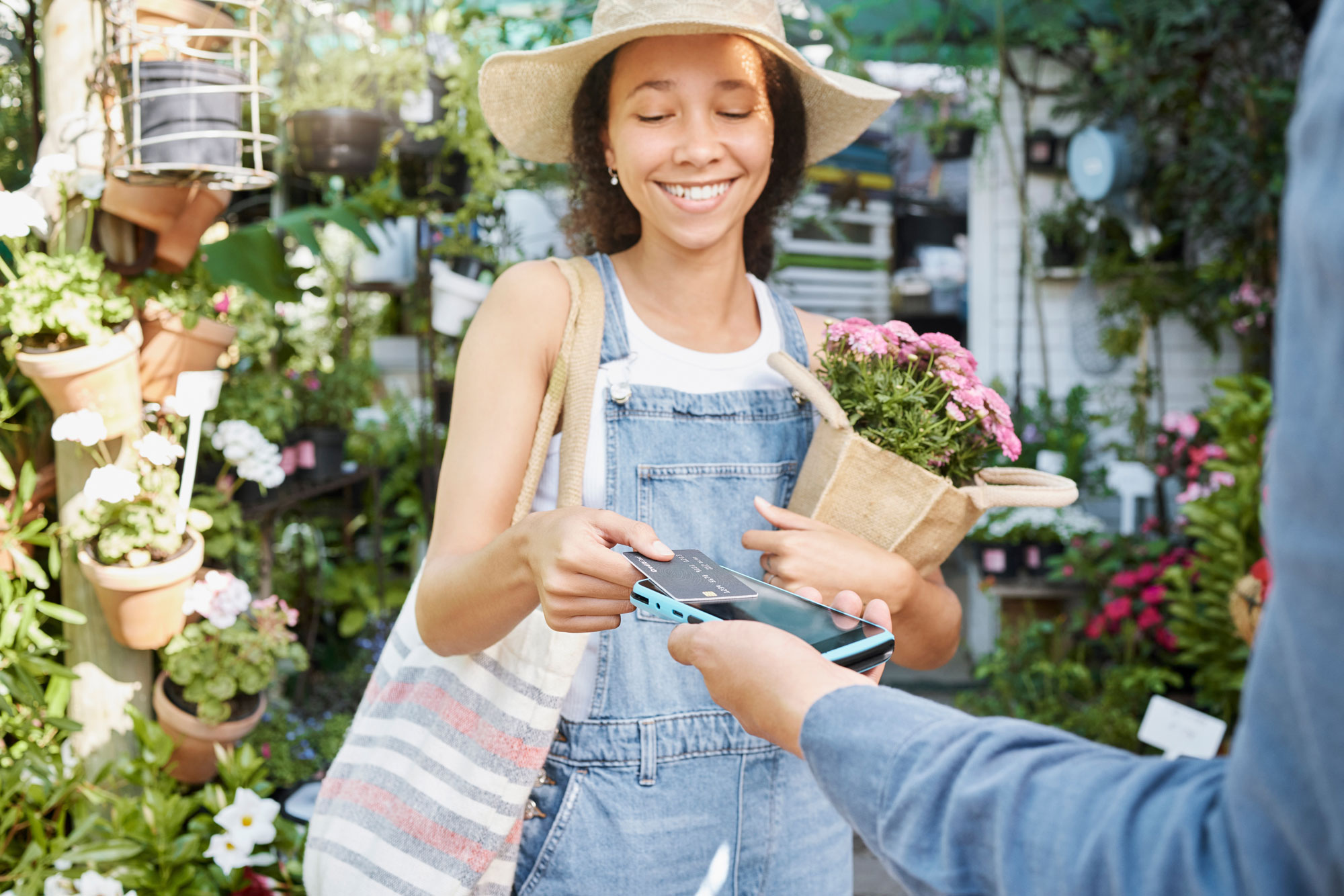 Flower shop customer using PayBill Tap To Pay Anywhere app